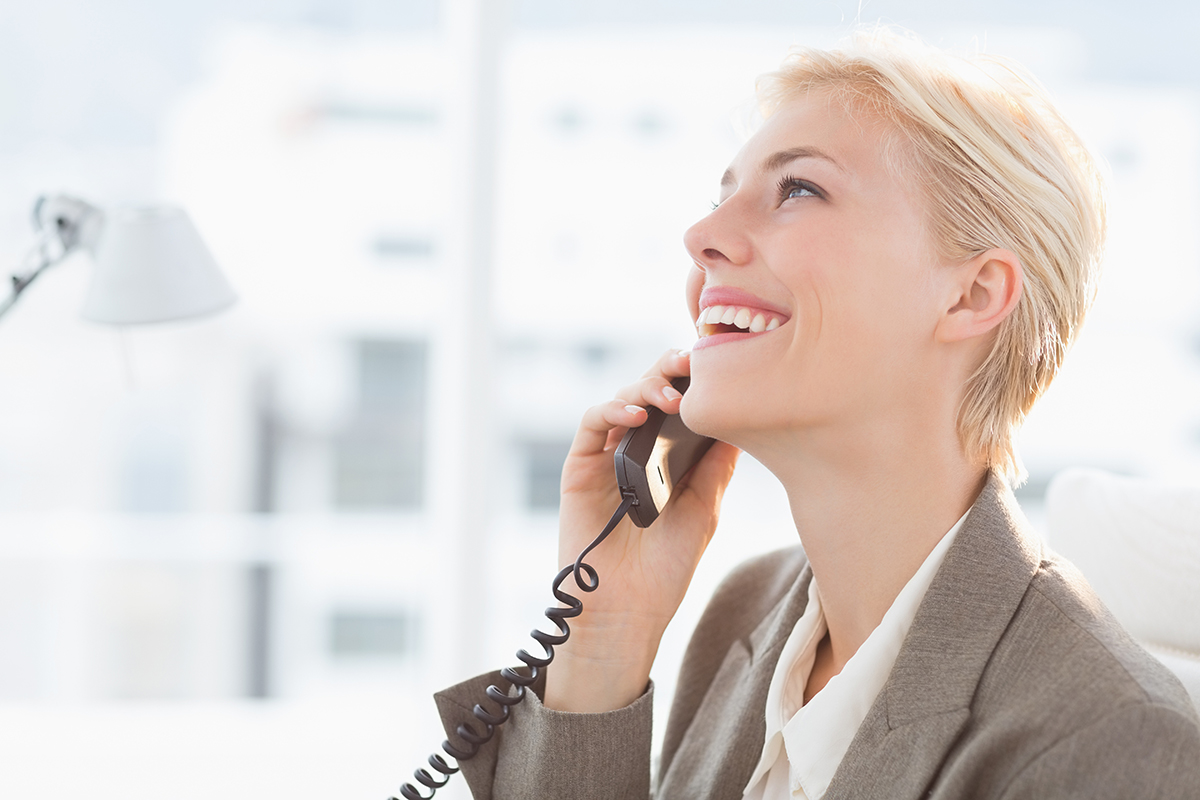 Business woman smiling while talking on the phone