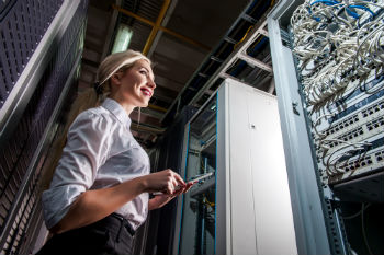 Woman standing in front of a server rack